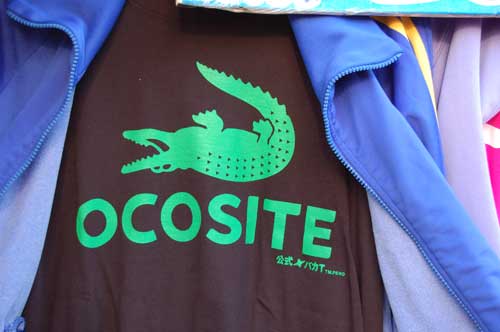 This is of course a spoof of Lacoste. Loosely translated it means "turn me over".